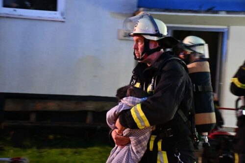 Eilig: Ein Feuerwehrmann trägt die erste der beiden Katzen aus dem Haus. Foto: Feuerwehr Dortmund