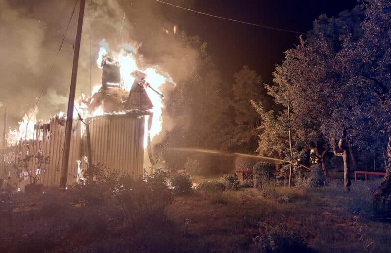 Einsatzkräfte der Feuerwehr München löschen ein brennendes Gebäude. 